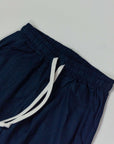 Close-up of Paros Pantalaccio waistband with elastic and drawstring in navy color.