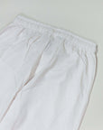 Comfortable white linen-rayon blend pants with elastic waistband for effortless style.