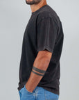Model wearing a black micro logo Amish Art T-shirt, made of 100% cotton, featuring a semi-over fit.