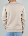 Back view of a man wearing a beige Felpa Superculture Girocollo St. Moritz sweatshirt.