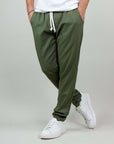 Comfortable green trousers with drawstring, paired with white sneakers, perfect for casual wear.
