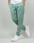 Comfortable mint green joggers with side pockets, paired with white sneakers and a simple white t-shirt.
