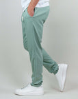 Side view of men's green pants made with a linen-rayon blend, paired with white sneakers.
