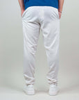 Rear view of a man wearing light-colored pantaloni misto lino, featuring a comfortable fit and casual style.
