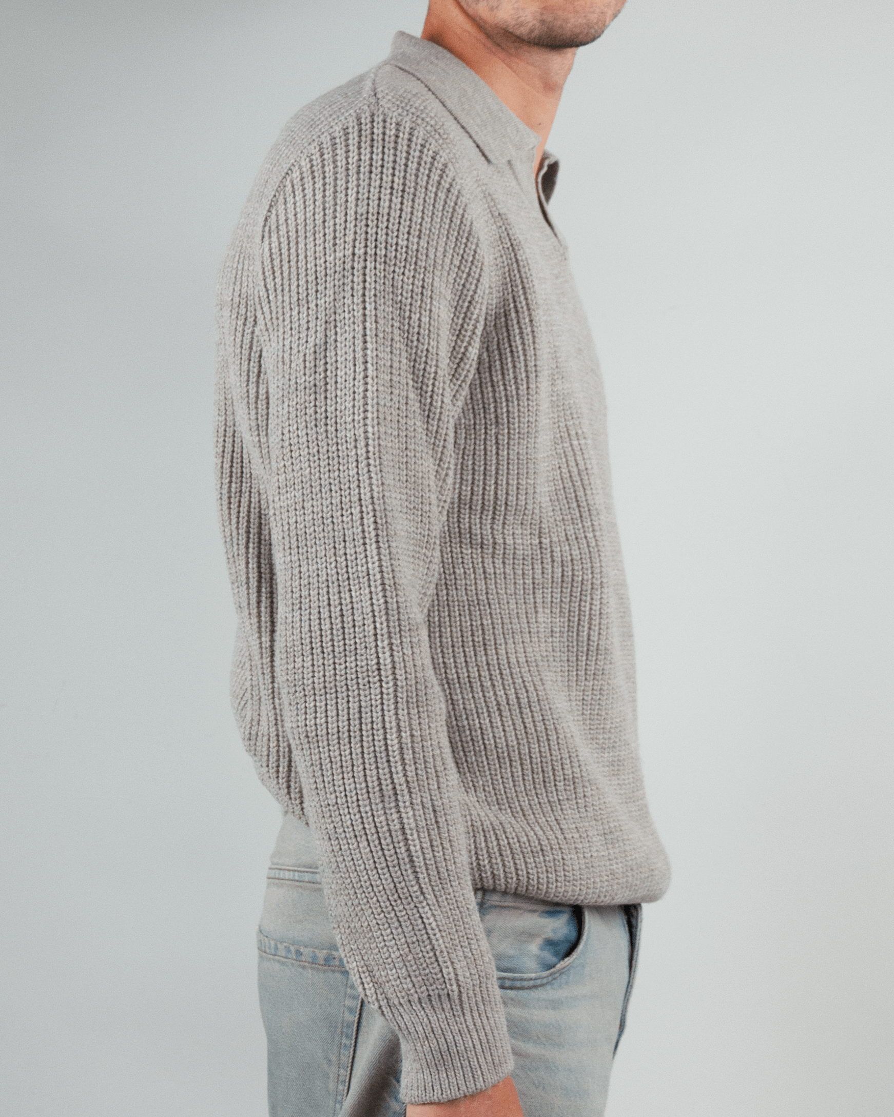 Maglia polo over Block Eleven side view, featuring a light gray ribbed design and long sleeves.