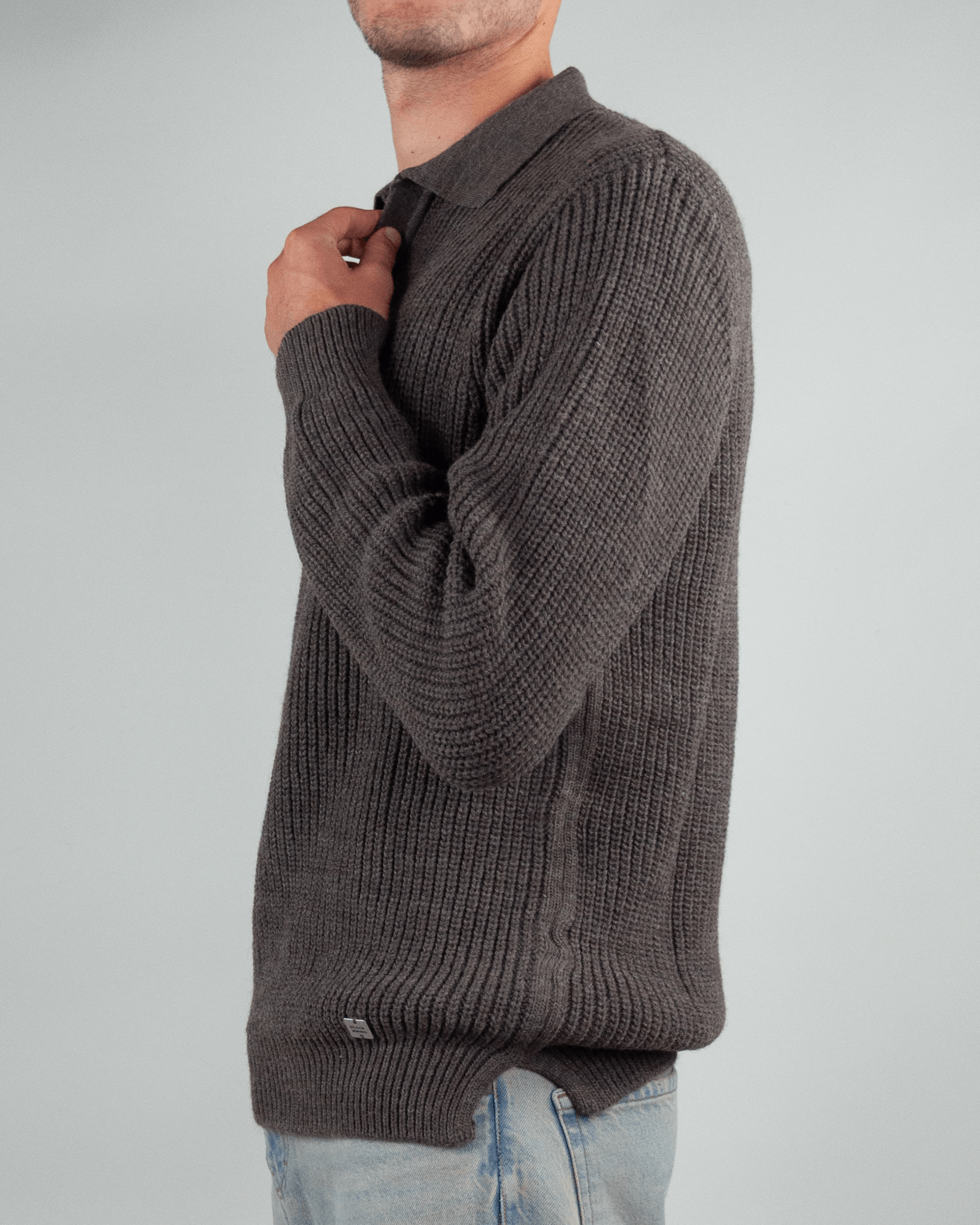 Man wearing a Maglia polo over Block Eleven in grey, showcasing its stylish knit design.
