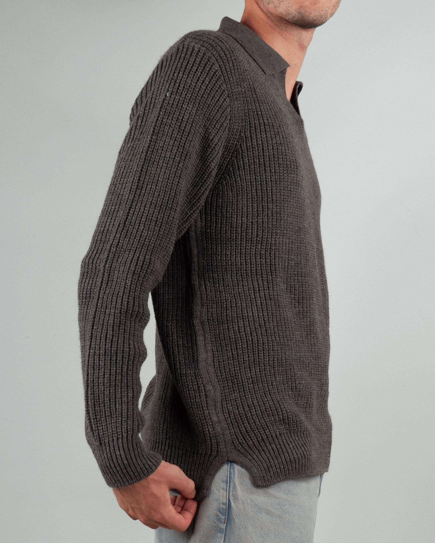 Side view of a man wearing a gray Maglia polo over Block Eleven, showcasing its textured knit design.