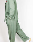 Abito doppiopetto Berna verde salvia worn by a model, featuring a stylish double-breasted design in sage green.