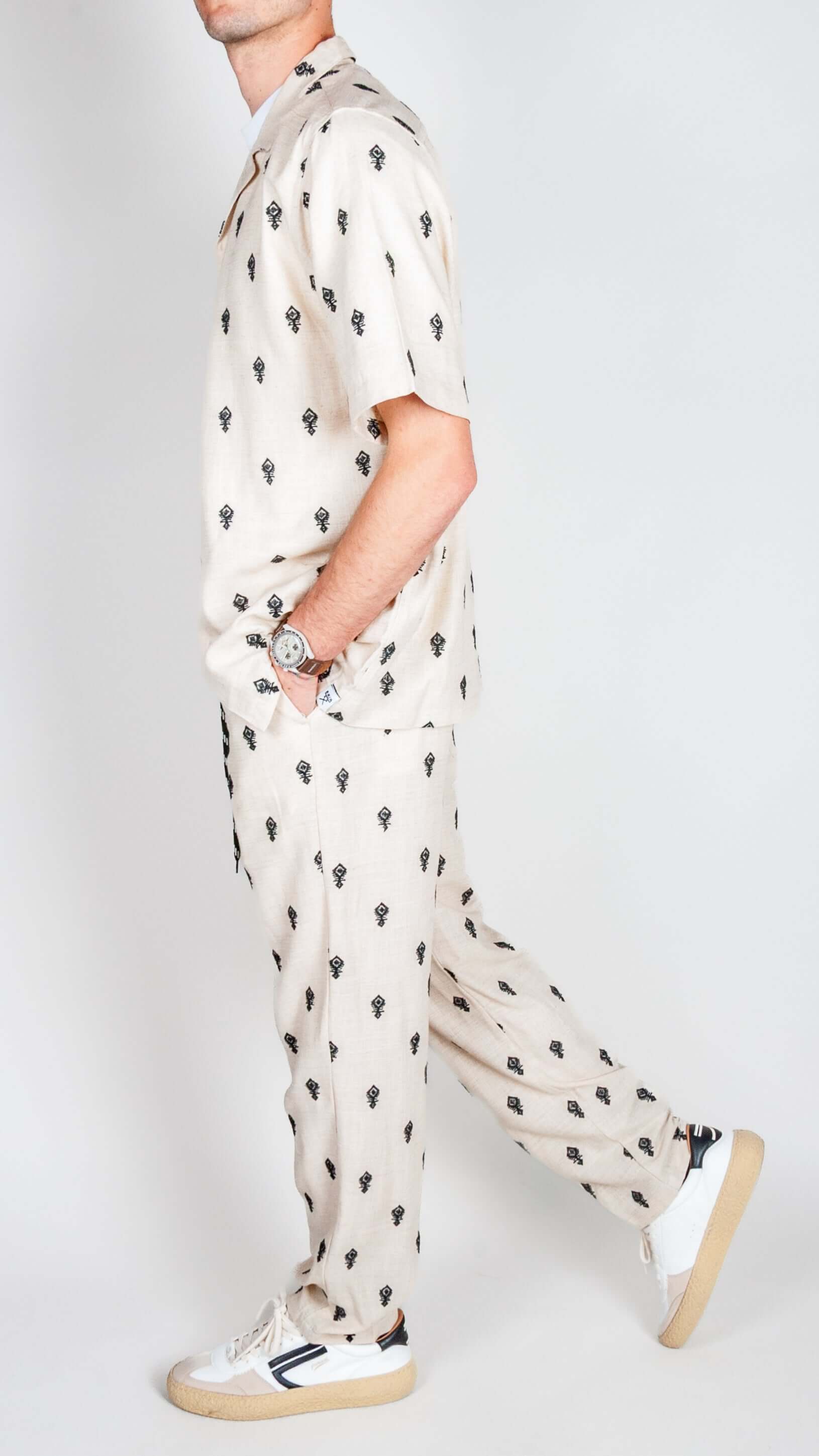 Completo Berna ricamo beige outfit with palm tree design, featuring shirt and pants.