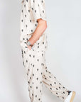 Completo Berna ricamo beige outfit with palm tree design, featuring shirt and pants.