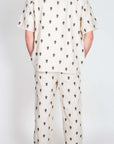 Completo Berna ricamo showcasing a stylish back view of the shirt and pants in a unique print design.