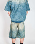 Completo in denim I'm Brian model from the back showcasing denim shirt and shorts.