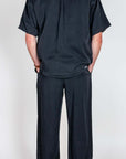 Completo in Lyocell Double Label Nero shown from the back, featuring a stylish black shirt and pants outfit.