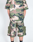 Completo Mimetico Why Not brand camouflage outfit seen from the back with shorts and short-sleeve shirt.