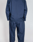 Model wearing Completo Popeline outfit in blue, showcasing the back view of the stylish two-piece set.