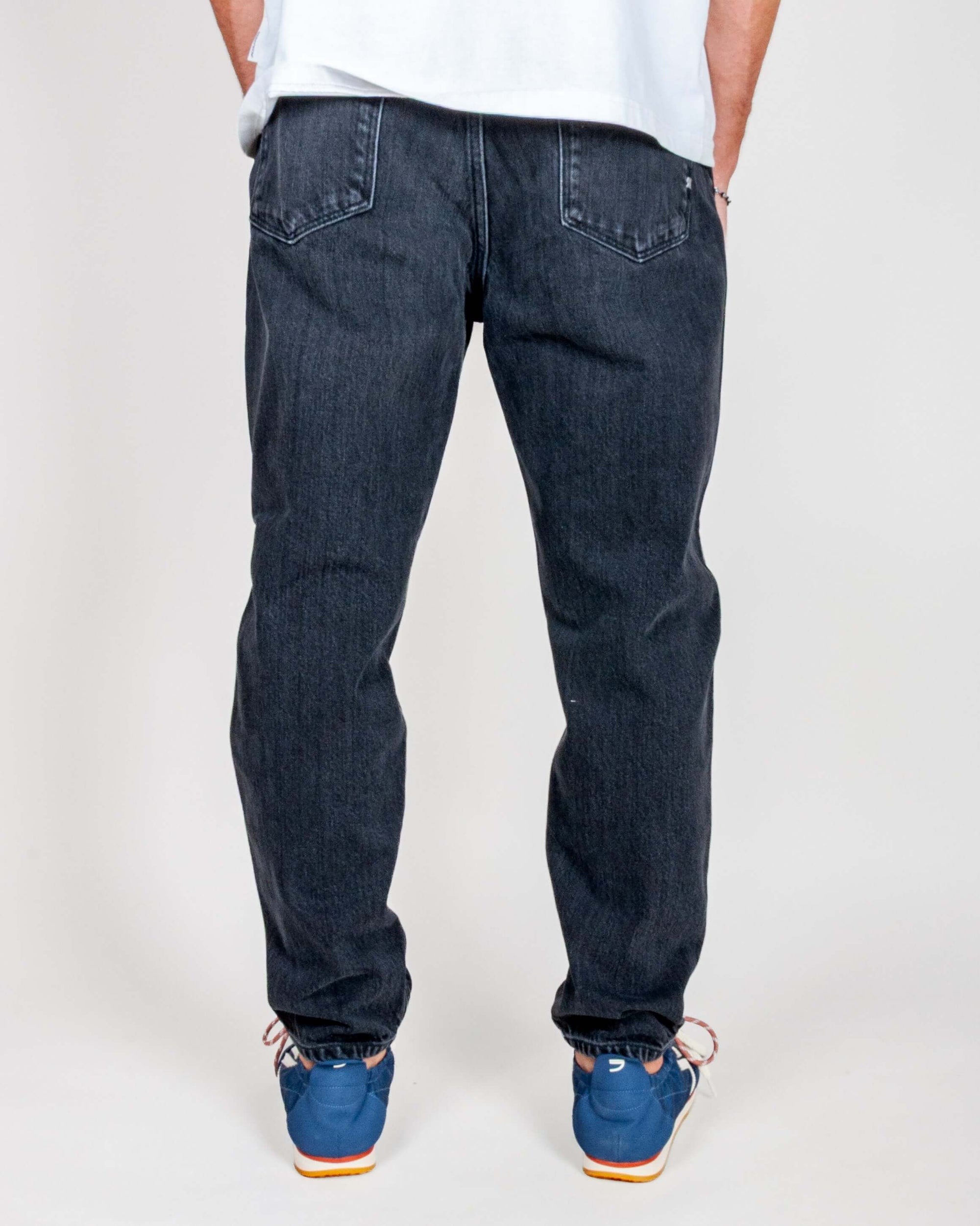 Jeans Jeremiah Uomo Black Used Amish Art. AMU001N0941788, view of the backside on a model wearing blue shoes.